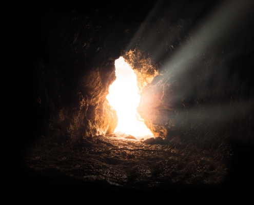 A light shines in the darkness of a cave